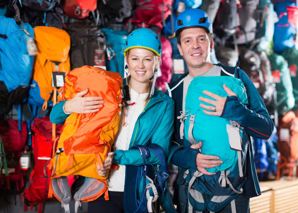 istock Glad couple in shop chooses backpacks 1051694334