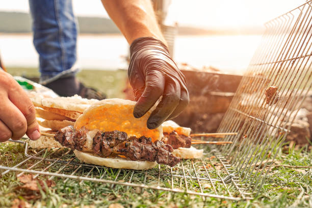 istock Cooking Shish kebab red meat on barbecue campfire 1051694696