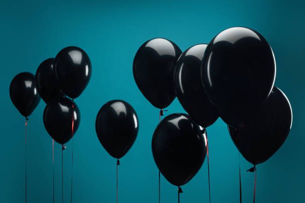 istock black balloons on blue for special offer on black friday 1051695434