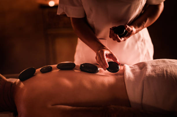 istock Unrecognizable man having therapy with hot stones at the spa. 1051697874