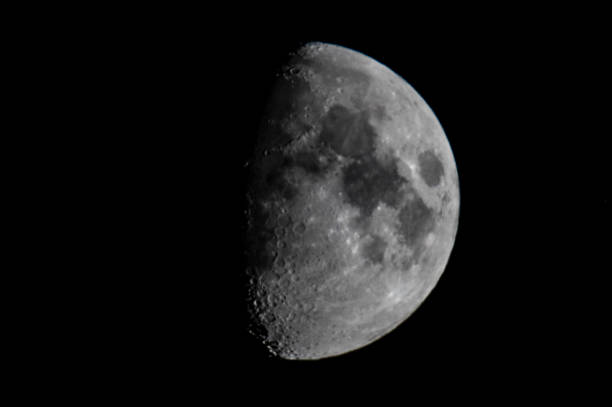 istock Moon in the dark night sky in the first quarter 1051698636