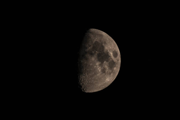 istock Moon in the dark night sky in the first quarter 1051699340