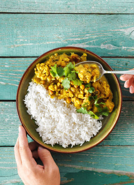 istock Man is eating cauliflower spicy curry with rice 1051699596