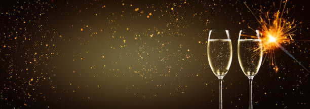 istock champagne glasses and sparkler in the night 1051699616