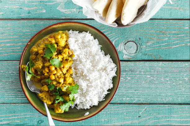 istock Cauliflower spicy curry with rice naan bread 1051701922