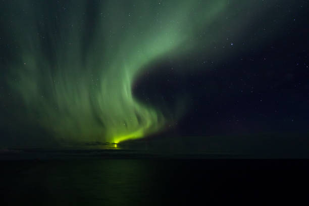 istock The greenish aurora vibrates in the sky 1051703070