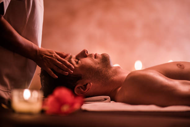 istock Young man receiving head massage at the spa. 1051703112