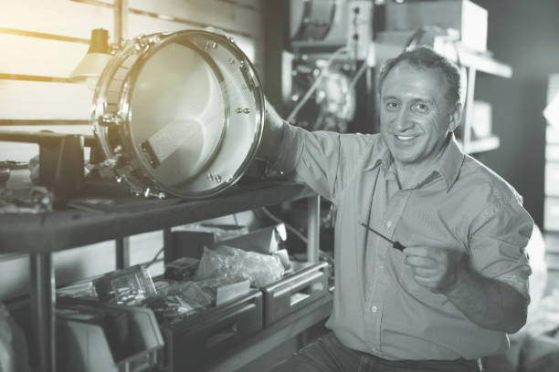 istock Smiling musician is repairing instruments in studio 1051705910