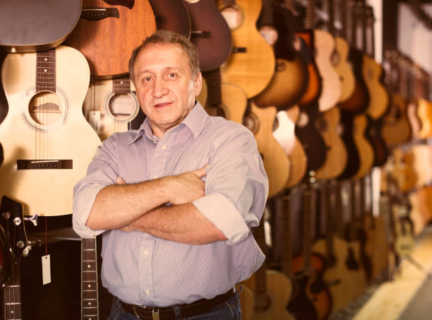 istock Mature man choosing acoustic guitar 1051708078