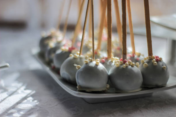 istock Sweet balls on sticks covered with white chocolate and air grains 1051712692