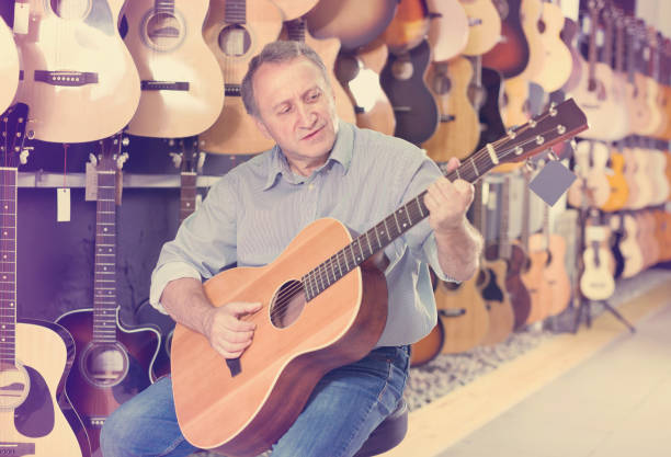 istock male is playing on acoustic guitar 1051713394