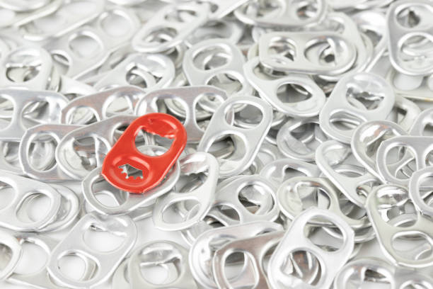 istock red aluminium ring pull opener among silver ring tabs , concept : different, out standing, recycle ringpulls for disable prostheses. 1051713586