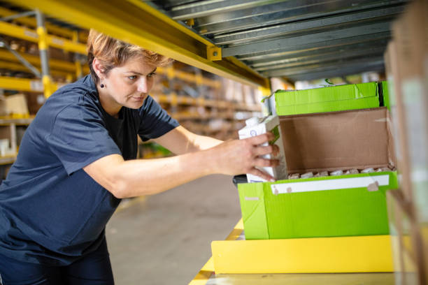 istock Woman arranging cartons in warehouse 1051716522