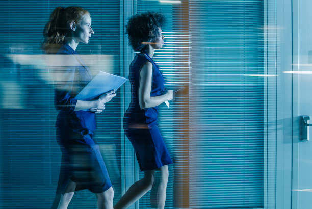istock Businesswomen Walking Down The Hallway 1051717208