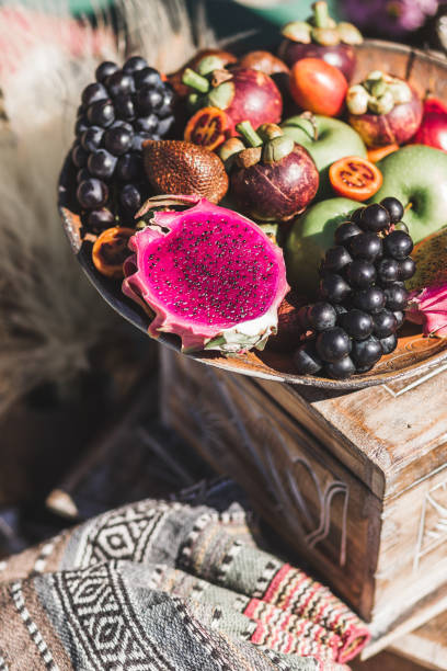 Fruit plate with apple, passion fruit, grape, mangosteen, dragonfruit on wooden plate