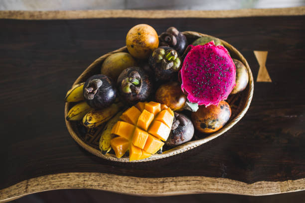 Fruit plate with mango, passion fruit, mangosteen, dragonfruit on wooden table