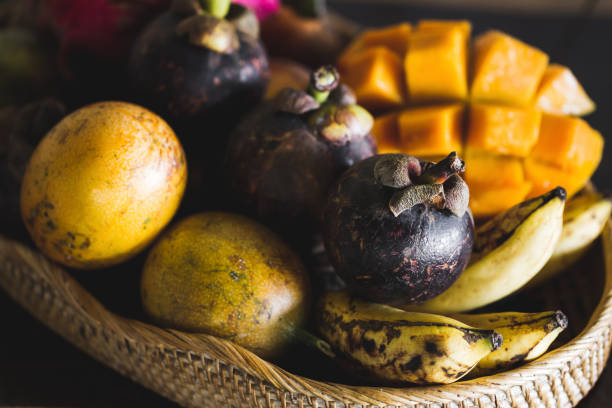 Fruit plate with mango, passion fruit, mangosteen, dragonfruit on wooden table