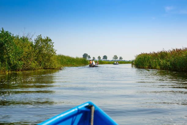 Giethoorn, Netherlands, August 20, 2015 - The unknown tourists on the sightseeing boats in the Dutch fairytale village.