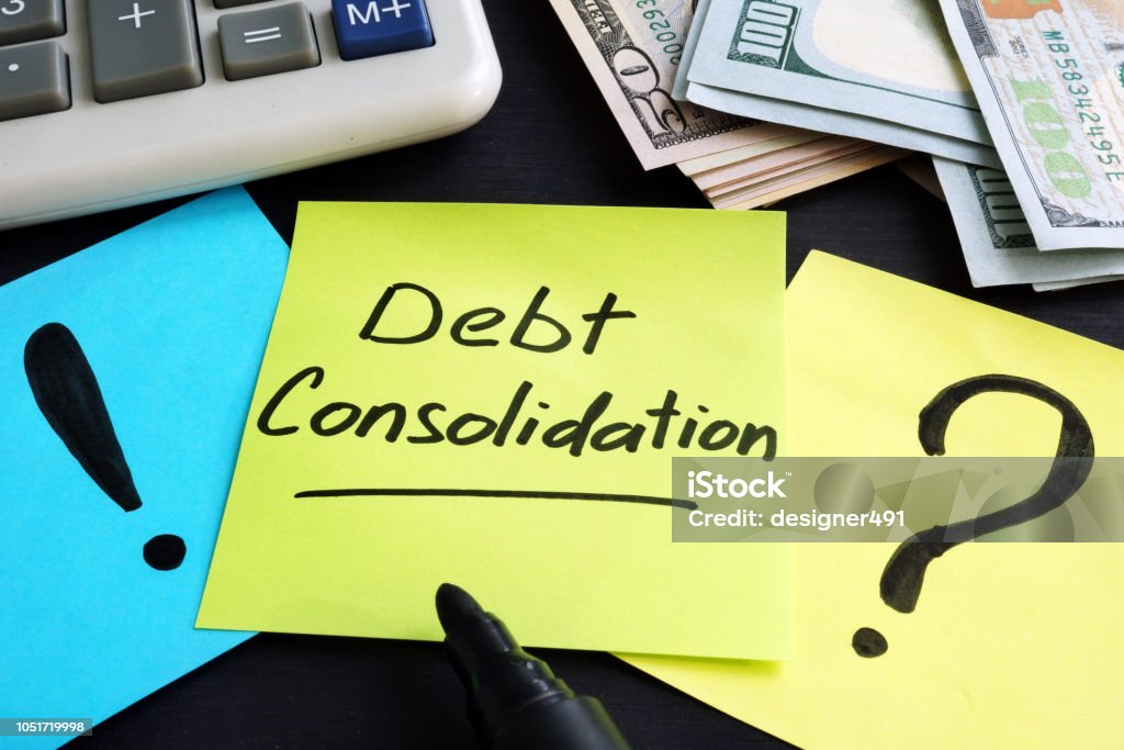Debt consolidation written by hand and money. Debt Consolidation Stock Photo