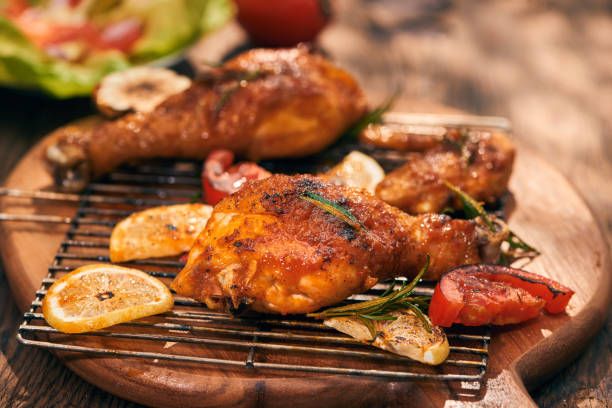istock Grilled bbq chicken with fresh herbs and tomatoes 1051720072