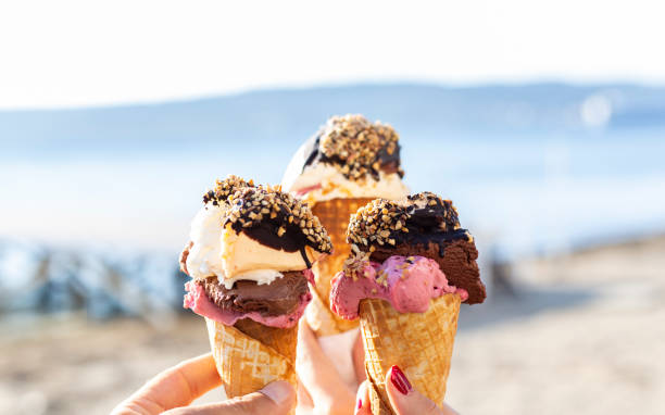 They are eating icecream at the wonderful weekend. Ice cream and view of seaside. ruddy turnstone stock pictures, royalty-free photos & images