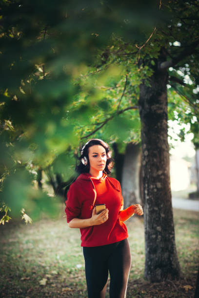 istock Sports girl  runs through the forest. 1051720728