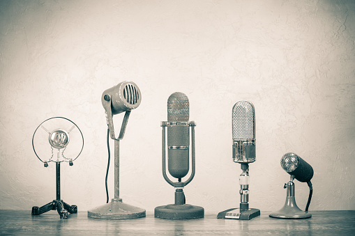 Retro microphones for press conference or interview. Vintage old style sepia photo