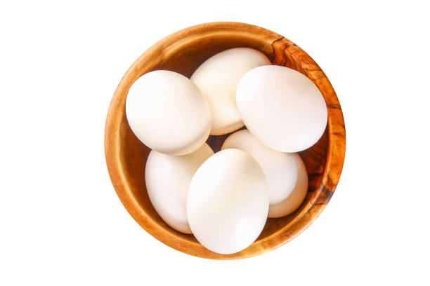 istock Chicken eggs. Eggs isolated on white background. Top view. Chicken eggs in a wooden bowl. Egg isolate. 1051726698