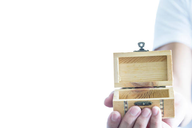 istock Man has give a surprise present with empty wooden treasure. Selective focus and isolated and white background concept. 1051728324