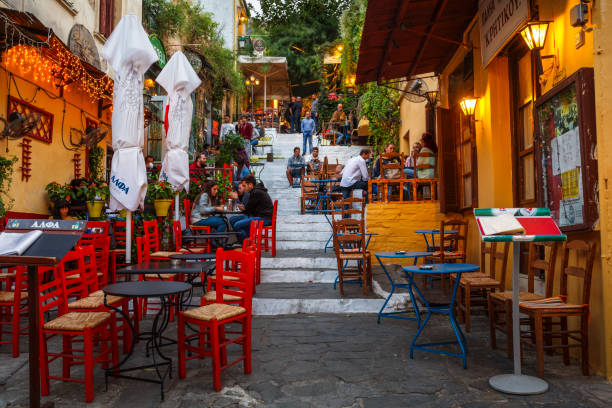 Athens Athens, Greece - September 26, 2018: People sitting in coffee shops in a street of Plaka district in Athens, Greece. "n plaka athens stock pictures, royalty-free photos & images