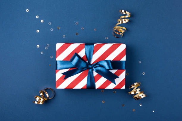 istock Gift box with blue ribbon decorated with sparkles. 1051728846