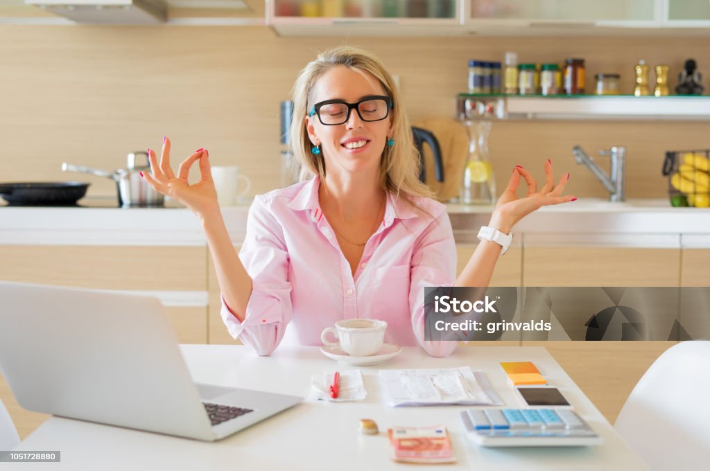 Financially free and calm housewife sitting in kitchen Financially free and calm Caucasian ethnicity housewife sitting in kitchen Freedom Stock Photo