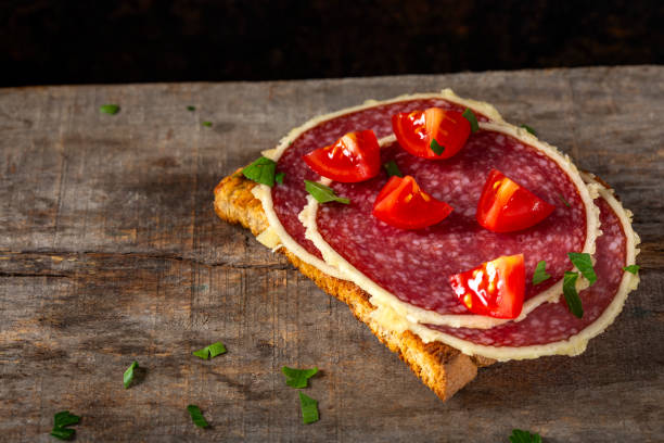 istock Open sandwich with salami surrounded by parmesan cheese 1051731180