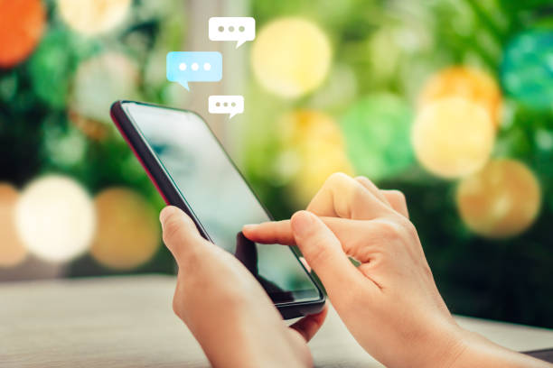 istock Women hand using smartphone typing, chatting conversation in chat box icons pop up. Social media maketing technology concept.Vintage soft color tone background. 1051746172