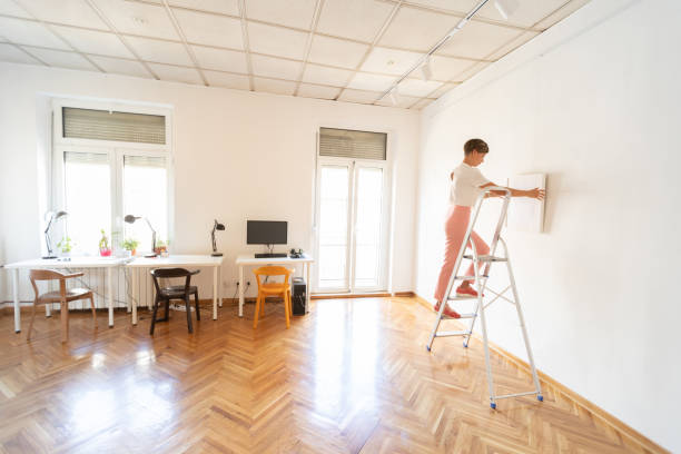 istock Holding picture frame against the wall 1051746638