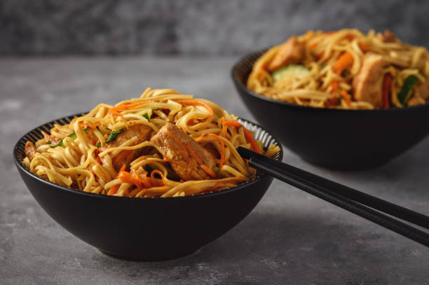 istock Spicy asian noodles with chicken and vegetables. 1051746926