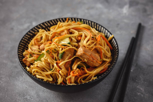 istock Spicy asian noodles with chicken and vegetables. 1051746936