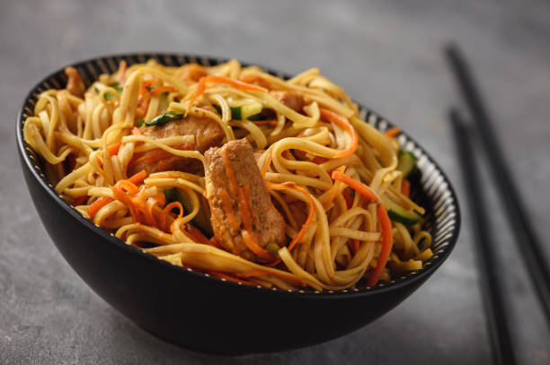 istock Spicy asian noodles with chicken and vegetables. 1051746944