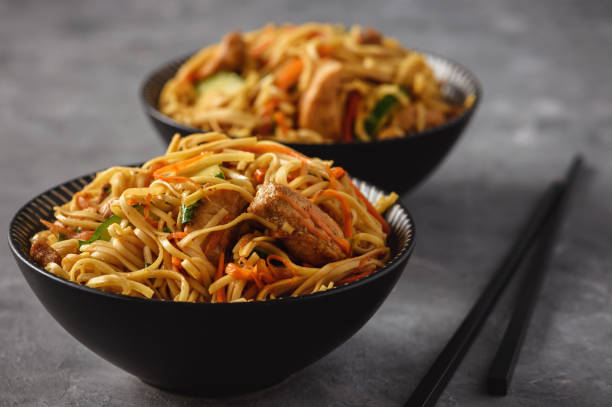istock Spicy asian noodles with chicken and vegetables. 1051746946
