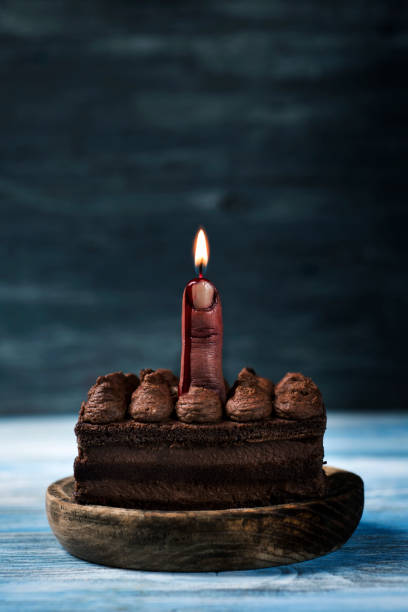 istock bloody middle finger with a lit wick on a cake 1051749770
