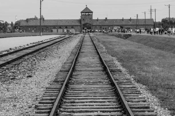 Memorial and museum Auschwitz-Birkenau Former German Nazi Concentration and extermination camp Oswiecim, Poland on August 11, 2018: These rails led to extermination camp Auschwitz. It became the symbol of the "Shoa". At the Auschwitz extermination camp, about 1.1 million people, including one million Jews, were systematically murdered. holocaust stock pictures, royalty-free photos & images