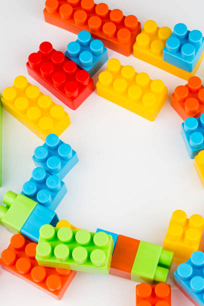 istock Children toys; colorful plastic blocks on the white background. 1051753530