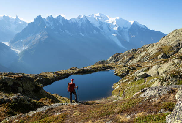 Lac des Cheserys Hiker looking at Lac des Cheserys on the famour Tour du Mont Blanc near Chamonix, France. chamonix photos stock pictures, royalty-free photos & images