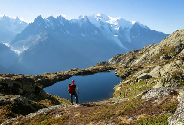 Hiker looking at Lac des Cheserys on the famour Tour du Mont Blanc near Chamonix, France.