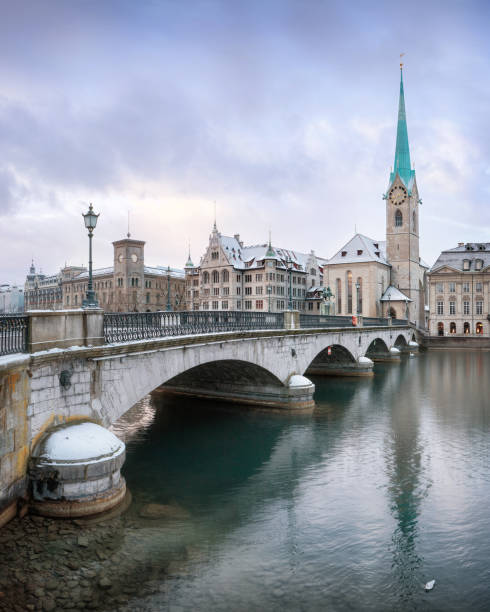 Old Zurich town in winter, view on lake Winter landscape of Zurich with lake with bridge on foreground, Switzerland switzerland zurich architecture church stock pictures, royalty-free photos & images