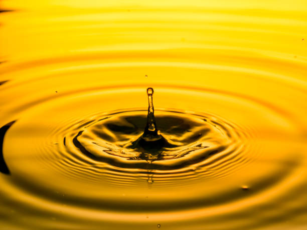istock Close-Up Of Drop Falling In Water 1051768814