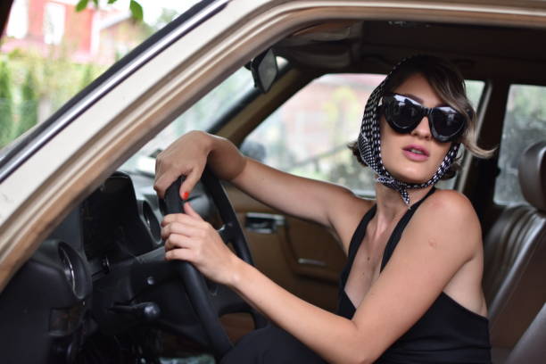 istock stylish woman model in a retro car 1051773680