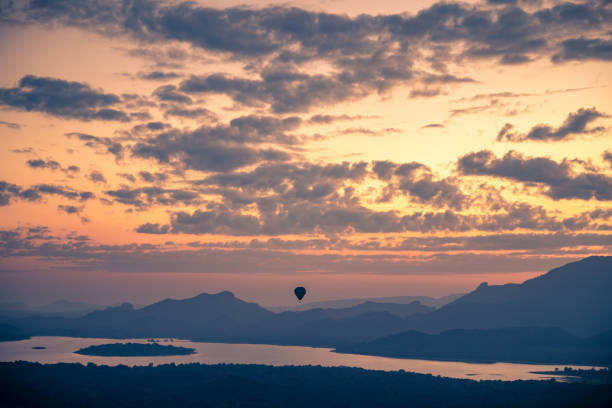 Hot air balloon in the sky, beautiful view of amazing cloudy sunset sky over mountains, summer traveling to Sigiriya, Sri Lanka, South Asia