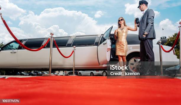 Driver Helping Vip Woman Or Star Out Of Limo On Red Carpet Stock Photo - Download Image Now