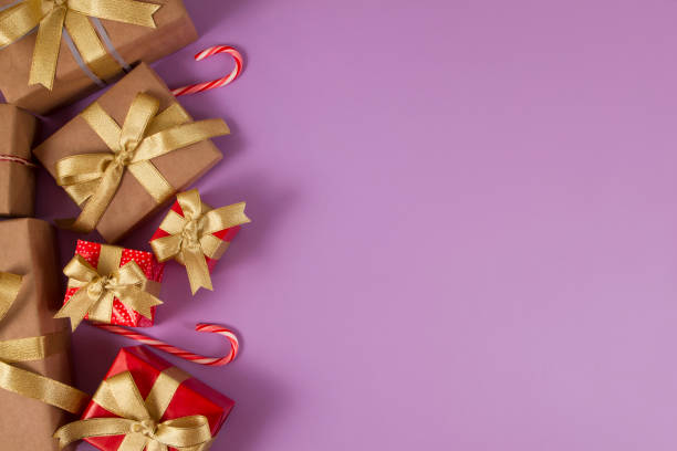istock Christmas Gift Boxes on Soft Purple Background 1051774566